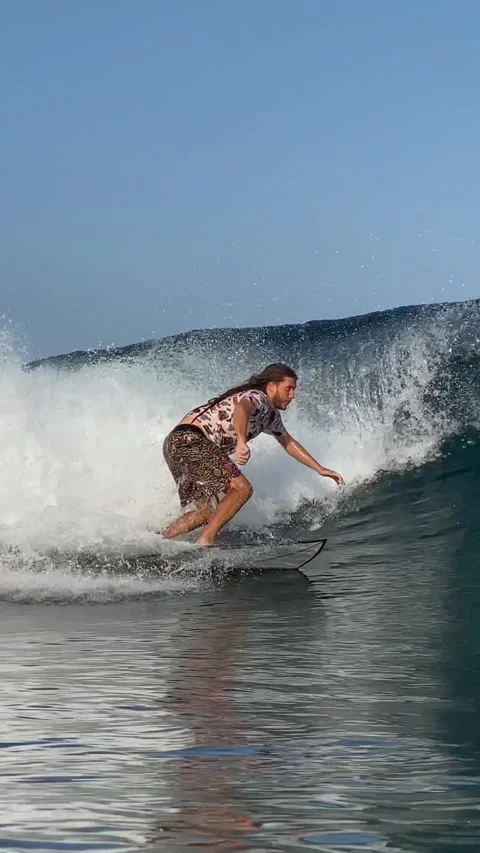 Young guy surfs in the ocean. Vertical video Stock Footage 300749918