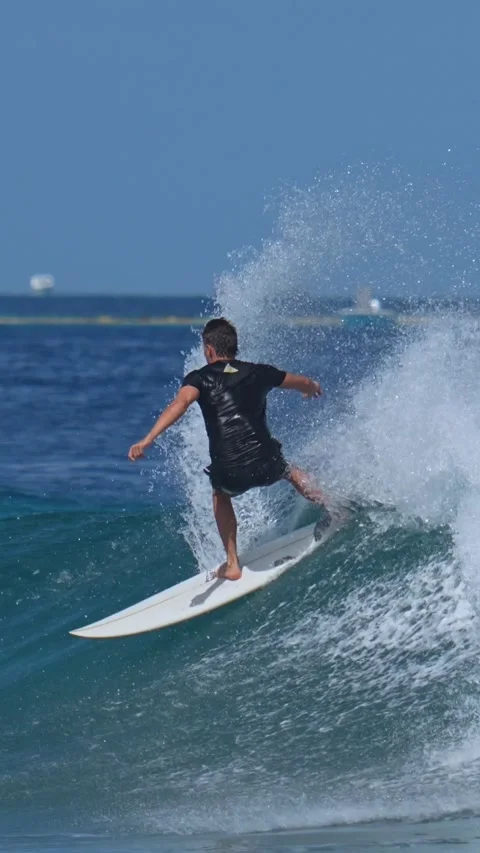 Young guy surfs in the ocean.Vertical video Stock Footage 300426108