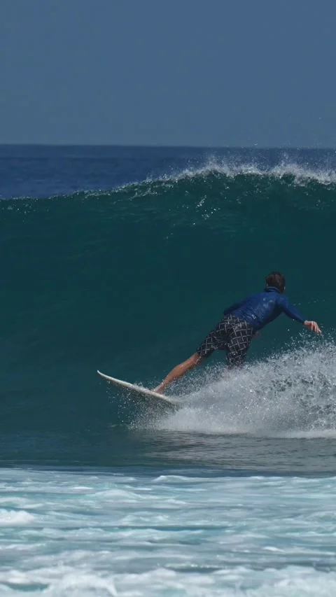 Young guy surfs in the ocean.Vertical video Stock Footage 300426169