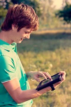Young guy with a tablet outdoors Stock-Fotos