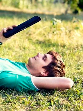 Young guy with a tablet outdoors Stock-Fotos