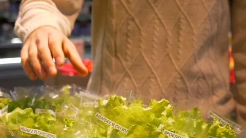 Young guy takes the hand lettuce and leaves. Healthy food. 4K footage Stock Footage 103597524