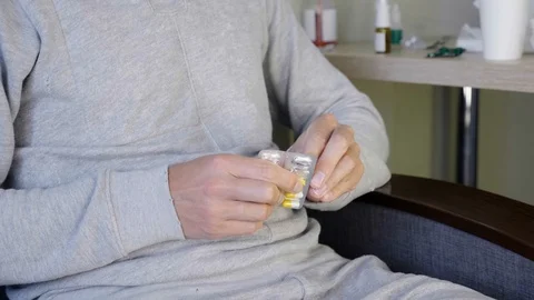 A young guy takes a pill Stock Footage 116031094