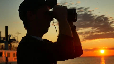 Young guy takes pleasure the sunset on lake Balaton water with binocular Video stock 116100668