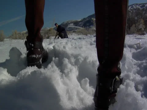 A young guy takes the snows between someone's feet gap Stock Footage 23052390