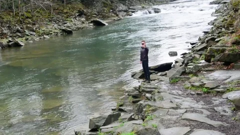 A young guy takes a video of a mountain landscape on a mobile and makes a selfie Video stock 83431648