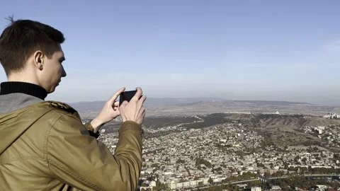 A young guy takes a view of the city Stock Footage 222923641