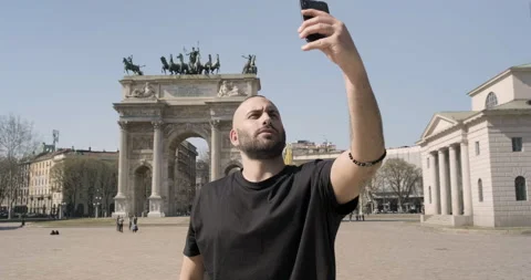 Young guy taking selfies at the Arco della Pace, Milan, Italy Stock Footage 172533884