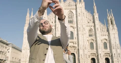 Young guy taking selfies at the Duomo cathedral, Milan, Italy Stock Footage 172533933