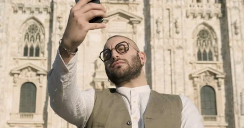 Young guy taking selfies at the Duomo cathedral, Milan, Italy Stock Footage 172533968