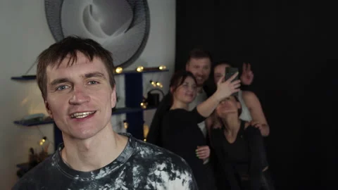 Young guy talk to the camera while the classmates making selfie Stock Footage 157186832
