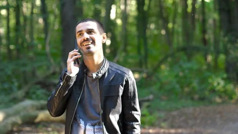 Young guy talking on the phone in the forest Stock Footage 116782147