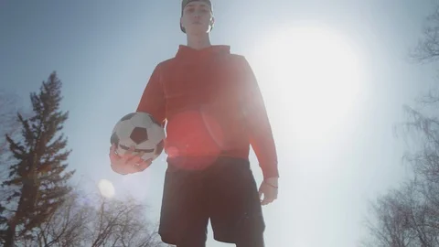 A young guy throws a soccer ball with his feet. Street football. Slow motion, 4K Stock Footage 114133085