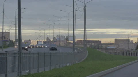 Young guy in town on a skateboard with a tablet in hand in the summer Stock Footage 65372012