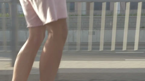Young guy in town on a skateboard with a tablet in hand in the summer Stock Footage 65376526