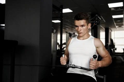 Young guy is training in the gym Stock Photos