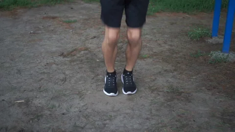 Young guy training in the park. Jumping rope exercises. Close up feet Stock Footage 160165294