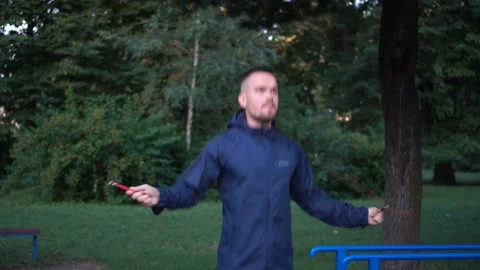 Young guy training in the park. Jumping rope exercises Stock Footage 160165384