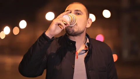 Young guy tries disgusting coffee posing in front of the camera Stock Footage 99740558