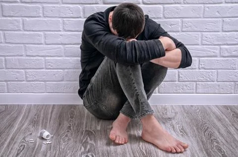 A young guy is trying to commit suicide. The guy is trying to give up drugs.  Stock Photos