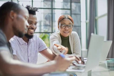 Young guy uses the phone while sitting at the table ce Stock Photos