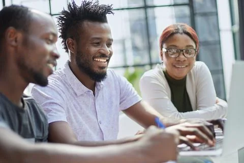 Young guy uses the phone while sitting at the table ce Stock Photos