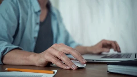 Young guy using laptop in office. Male hands with a wireless mouse Stock Footage 79902206