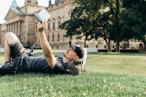 A young guy is using a tablet. Stock Photos