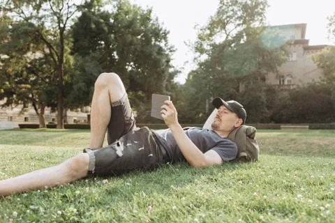 A young guy is using a tablet. Stock Photos