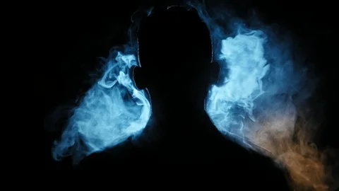 Young guy vaping in the dark room. Silhouette of vaper in the darkness lighted Video stock 106471182