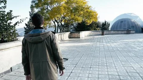 A young guy. View from the back. City, and good view. Stock Photos