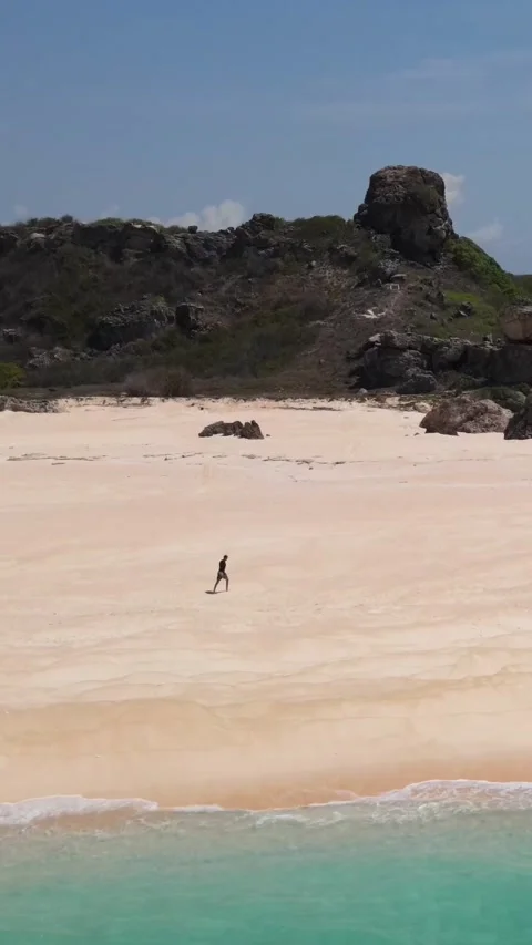 Young guy walking on the beach.Vertical video Stock Footage 300659345