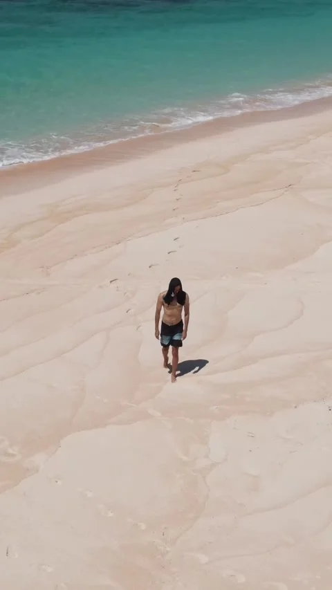 Young guy walking on the beach.Vertical video Stock Footage 300659349