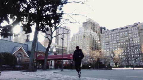 Young guy walking on his back in a mysterious city Stock Footage 136203558