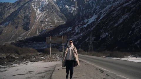 A young guy is walking in the mountains Stock Footage 169811208