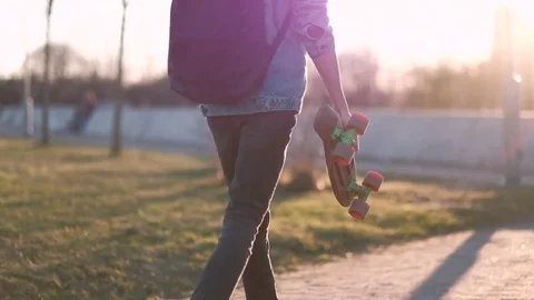 Young Guy Walking With a Skateboard in Hands Stock Footage 75251040