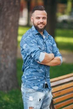 Young guy walking in the spring park. Sunny day. Vesna.Funny guy. A good mood Stock Photos