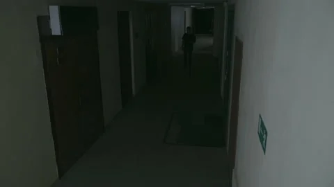 A young guy walks along a dark corridor 库存影片 155905731
