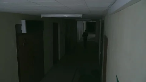 A young guy walks along a dark corridor 스톡 동영상 155905877