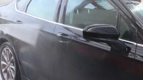 A young guy washes his car at a car wash Video stock 142700965