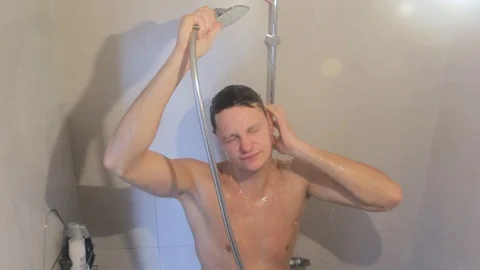 A young guy is washing in the shower Stock Footage 86364465