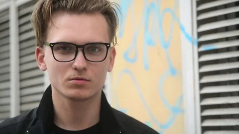 Young Guy wear Glasses Model in City Street posing for Fashion Photo Session Video stock 75329672
