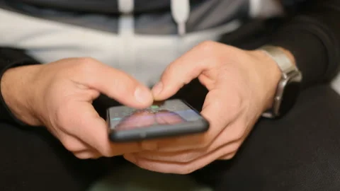Young Guy while using smartphone for messaging chat,cellphone tech addiction Stock Footage 148892777