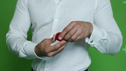 Young guy in a white shirt opens a box with a heel on a chrome background. Stock Footage 130830805