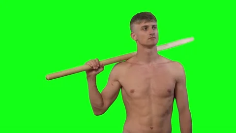 Young guy without clothes holds stick in his hand and looks around green screen Vidéo 239661685