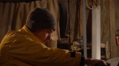 Young guy working in his little workshop.Close up Stock Footage 125858905
