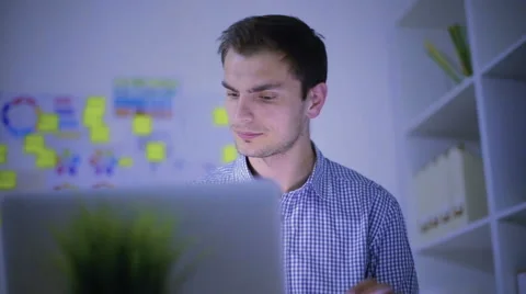 The young guy works behind the laptop Video stock 62550189