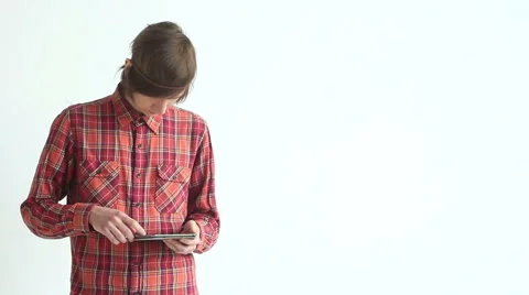 A young guy works with a tablet on white background Video stock 45440689
