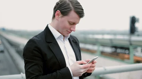 Young guy writes a message on the phone. Stock Footage 117674181