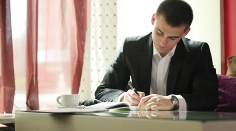 Young guy writing and laughing at camera Video stock 22769728